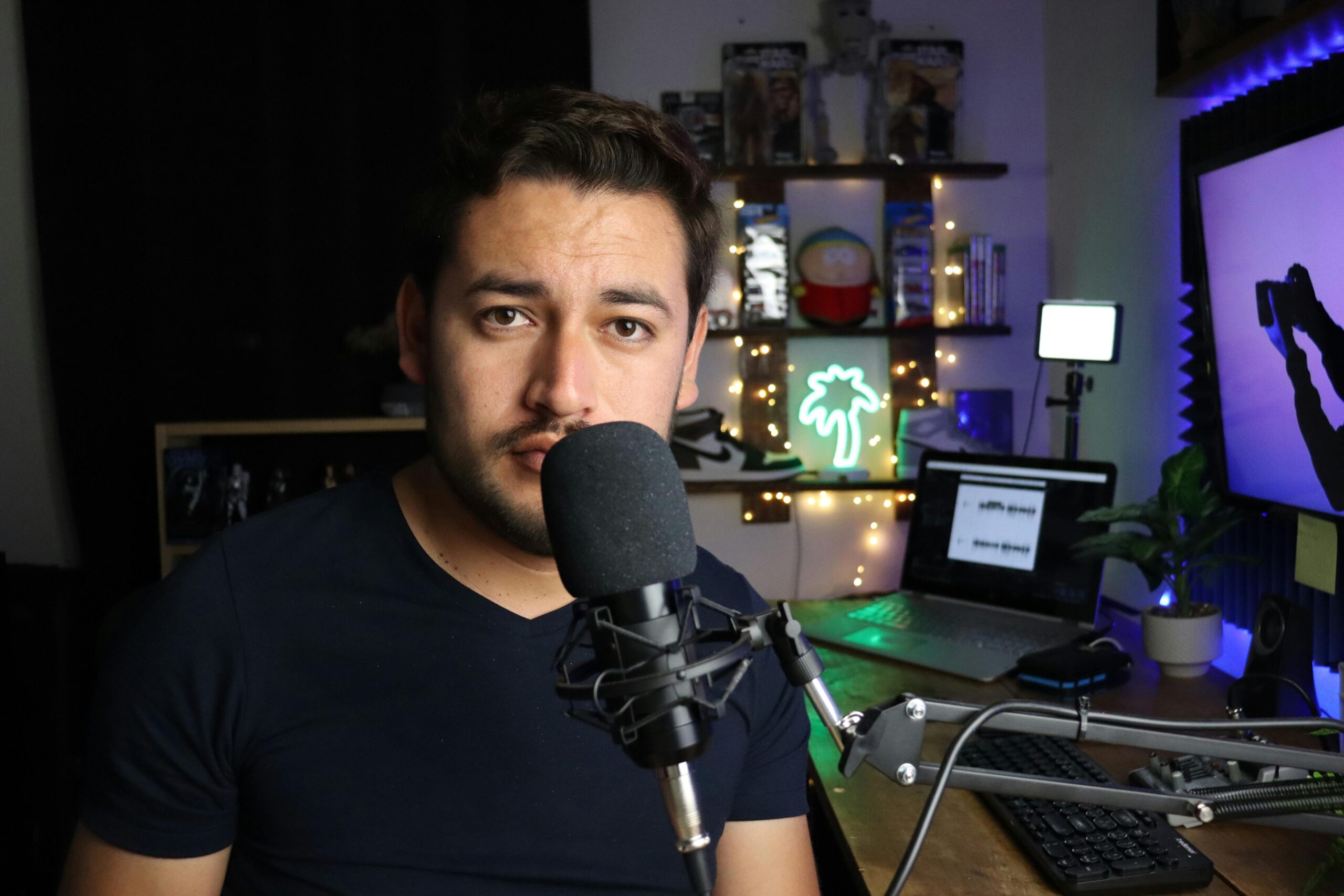Podcaster in a stylish home studio with microphone and neon lights in Santiago de Querétaro, Mexico.